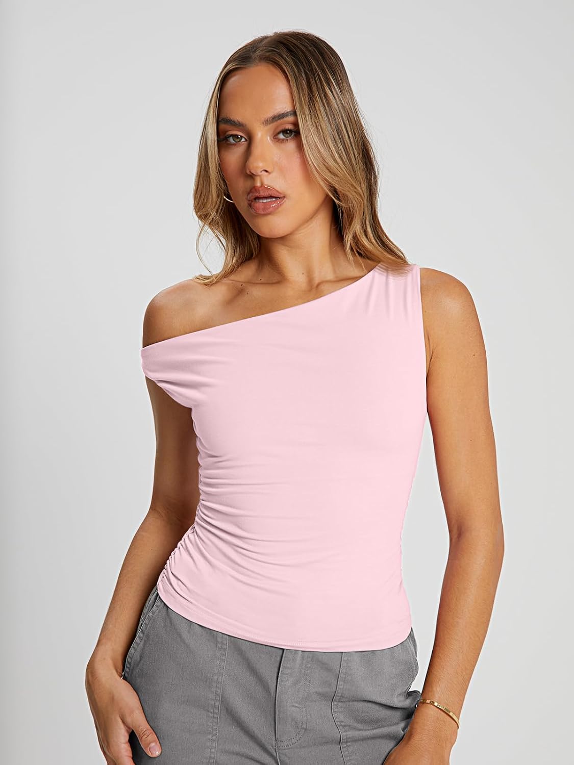 Soft, stretchy off-the-shoulder crop top with asymmetrical neckline; suitable for casual, going-out, or workout wear.