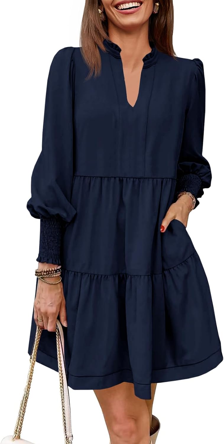 This charming dress features a flowy, tiered skirt and long blouson sleeves for a stylish, comfortable look that's perfect for any occasion.