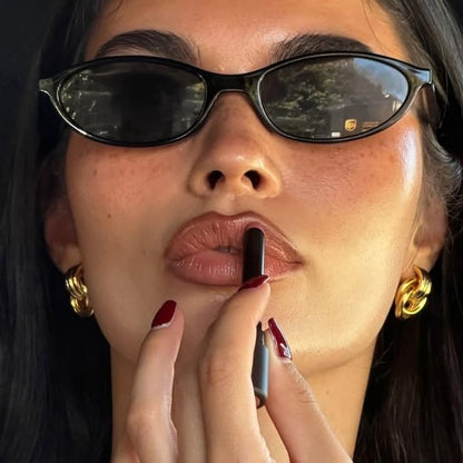 Lightweight, narrow oval sunglasses with a retro 90s vibe and 100% UV protection for vintage glamour.