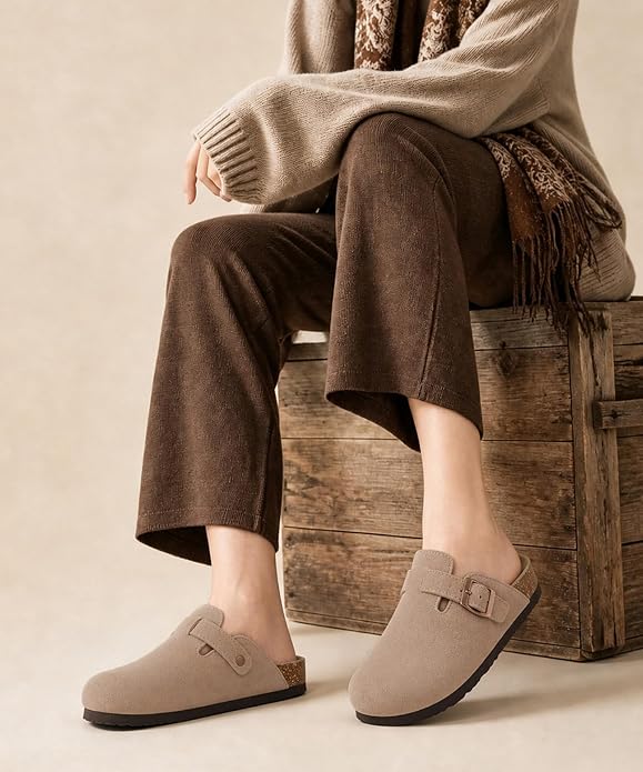 These genuine suede clogs from ODOLY feature a soft cork footbed, arch support, and an adjustable buckle for all-day comfort and a fashionable look.