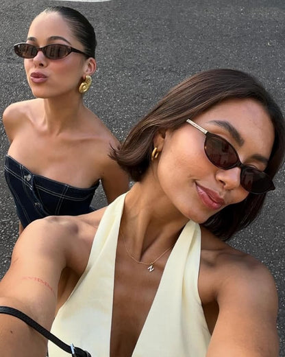 Lightweight, narrow oval sunglasses with a retro 90s vibe and 100% UV protection for vintage glamour.