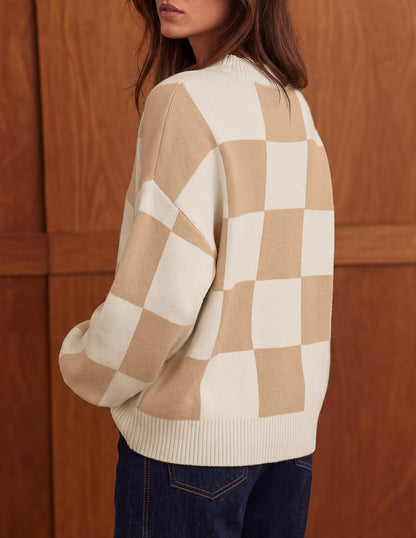 Soft, ribbed knit sweater with chic turtleneck, striped or plaid pattern, and loose, flattering fit for layering. It's a popular product!