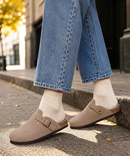 These genuine suede clogs from ODOLY feature a soft cork footbed, arch support, and an adjustable buckle for all-day comfort and a fashionable look.