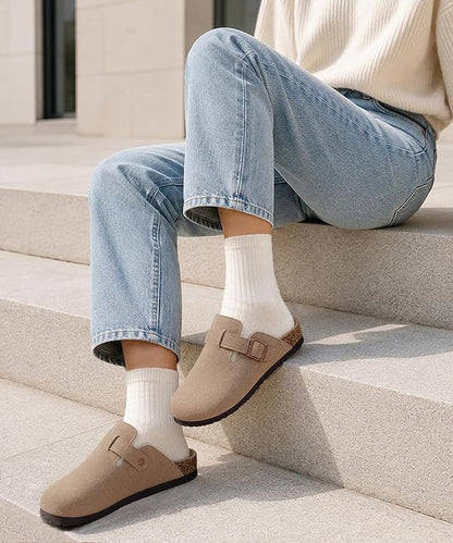 These genuine suede clogs from ODOLY feature a soft cork footbed, arch support, and an adjustable buckle for all-day comfort and a fashionable look.