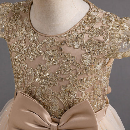 Exquisite lace dress with intricate golden lace design and charming bow detail for special occasions.