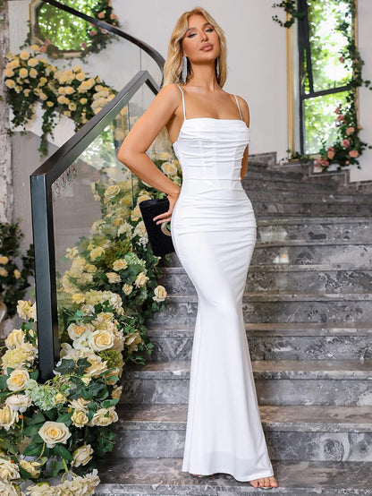 Elegant, ruched maxi dress with sleek silhouette, adjustable straps, and soft, stretchy fabric for formal occasions.