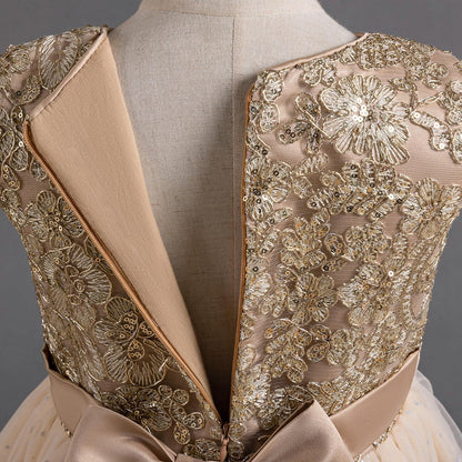 Exquisite lace dress with intricate golden lace design and charming bow detail for special occasions.